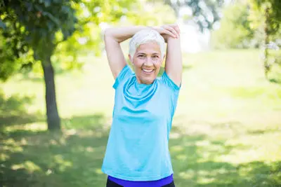 Woman in light blue with raised arms
