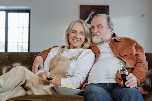Older couple relaxing on sofa